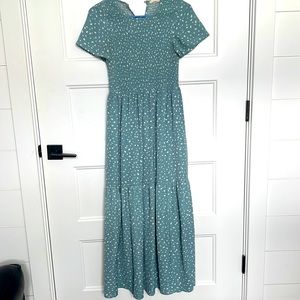Cute dotted dress, with rushing bodice. Button behind neck lined